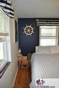 nautical themed bedroom makeover using blue and white home decorations. DIY valance, rope balls, mermaid painting, anchor, helm, lamps. | www.bexbernard.com